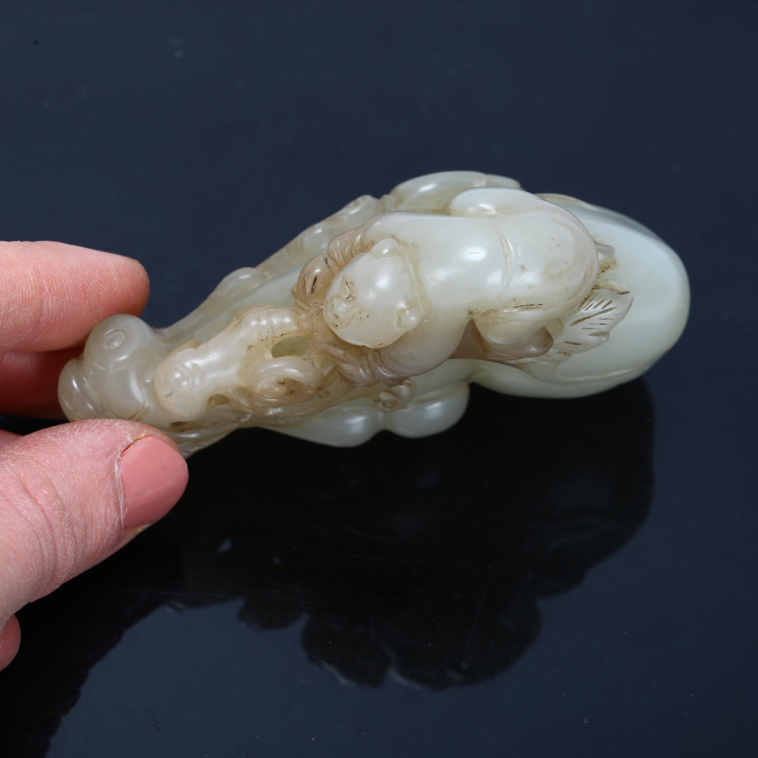 A Chinese carved jade ornament depicting a man climbing a double-gourd, length 8cm Good condition, - Bild 3 aus 3