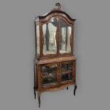 An Edwardian mahogany and marquetry inlaid vitrine cabinet, with shaped glazed panelled doors,