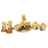 A group of Clarice Cliff Crocus pattern items, including a novelty stand with duckling handle,