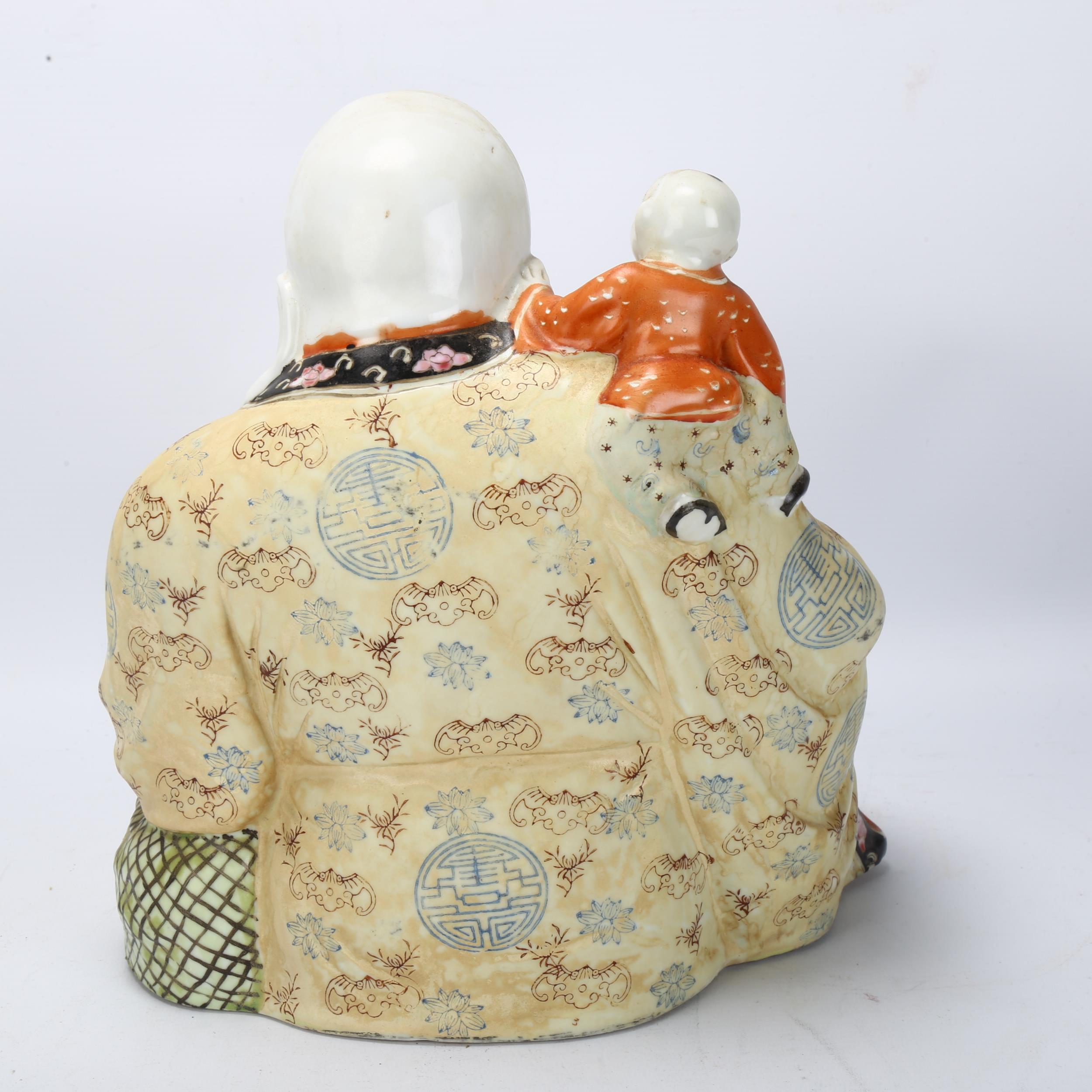 A Chinese porcelain Buddha with child on his shoulders, height 26cm No chips cracks or - Bild 2 aus 3