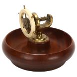 An Art Deco novelty ship's wheel design combination nut bowl and cracker, mahogany brass and