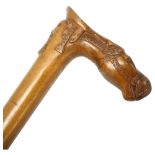 A Russian hardwood walking stick, the handle in the form of a combined horse head saddle and mask,