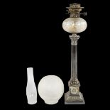 A late 19th century silver plated Corinthian column oil lamp with cut-glass well, with later shade