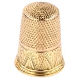 An Antique gold sewing thimble, bright-cut engraved decoration, stamped 14 and 9, thimble length