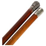 2 Malacca walking canes, 1 having an embossed Indian white metal handle, the other with a plated