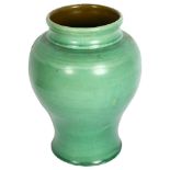 C H BRANNAM - a green glazed pottery vase of waisted form, height 21cm, incised C H Brannam
