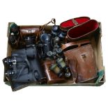 A quantity of Vintage binoculars and associated cases, mostly in A/F condition, some maker's
