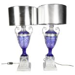 A pair of table lamps with silvered plinths and shades, and blue overlay cut-glass columns, height