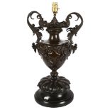 A large 19th Century patinated bronze 2-handled urn, with later conversion to a table lamp, on a