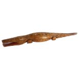 A carved wood crocodile, incised to the underside L Comaroves 1951, length 90cm