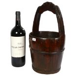 A Chinese wooden well bucket, height 62cm, and a shop display Rioja Vega bottle