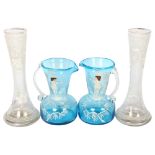 A pair of turquoise Mary Gregory design glass jugs, 12cm, and a pair of vases with floral decoration