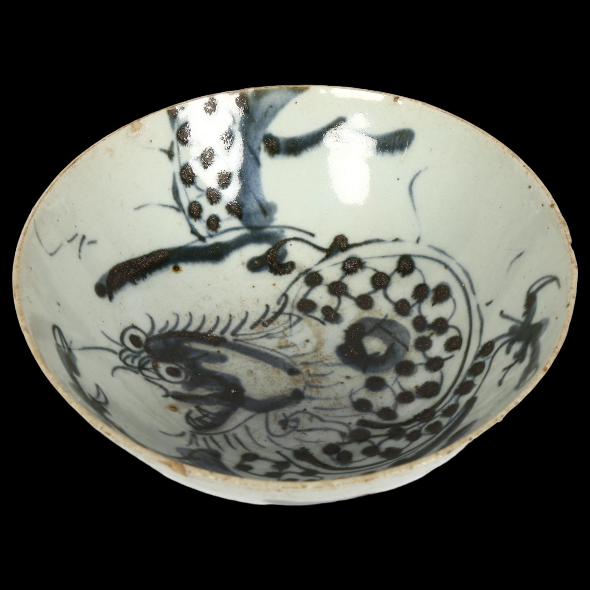 A Chinese blue and white pottery 'Dragon' footed bowl, diameter 16cm Several chips to bowl rim and