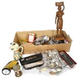 A box of interesting items, including harmonicas, whistles, fly ashtray, egg timer, cutlery etc