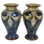 A pair of Royal Doulton stoneware vases, with embossed and painted swag decoration, height 27cm