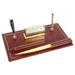 ASPREY'S OF LONDON - a red leather desk-top perpetual calendar and pen holder, with letter opener,