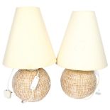 A pair of woven raffia table lamps, with cream shades, height 49cm