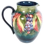 Antique Moorcroft jug with tube-lined fruit decoration, signed (A/F), height 19cm