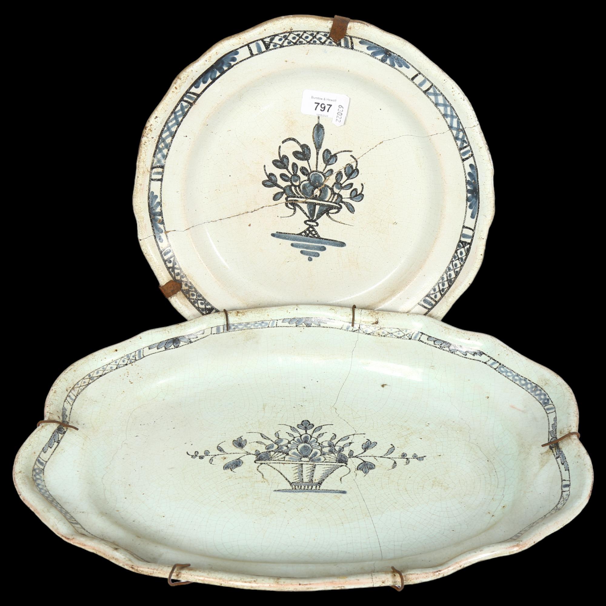 An early tin glazed earthenware blue and white plate with floral design, 32cm, and similar serving