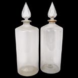 A pair of large Antique glass Chemist's bottles and stoppers, height 50cm