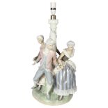 A large Lladro porcelain table lamp supported by 3 figures in Period costume, on plinth (A/F),