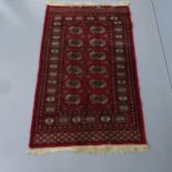 A red-ground Afghan rug. 132x80cm.