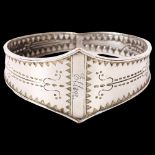 A Scandinavian Viking Revival bangle, with engraved decoration, unmarked silver settings, named to