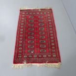 A red-ground Afghan rug. 126x80cm.
