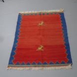 A red-ground Iranian Kilim rug. 148x108cm. Extensive repairs visible to centre.