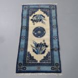 A cream and blue-ground Chinese mat. 114x59cm