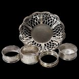 A small pierced silver dish with monogram centre, and 4 silver napkin rings, 3.2oz