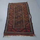 A salmon and brown ground Baluchi rug, 183x105cm.