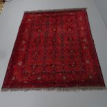 A red-ground Baluchi rug. 200x155cm Some areas of fading and wear. Fringe appears to have been