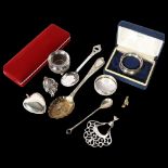 A tray of items to include a silver spoon and napkin ring, plated heart-shaped locket, plated salt