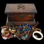 A quantity of costume jewellery, including carved nut necklace, bangle, Fossil wristwatch etc