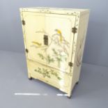 A modern white painted oriental two-door cabinet. 62x92x31cm