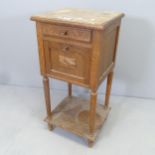 A Continental marble-top oak pot cupboard with carved and applied decoration and ceramic lined