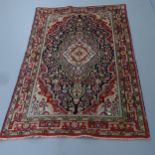 A cream ground Persian Hamadan rug. 204x133cm