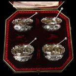 A Victorian silver salt set, comprising 4 salts with embossed decoration and 4 matching teaspoons,
