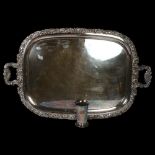 A large silver plate on copper 2-handled serving tray, with acanthus leaf and shell cast edge, on