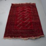 A red-ground Turkaman rug. 204x130cm.