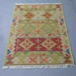 A cream-ground Kilim rug. 182x126cm.