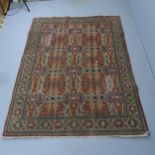 A cream-ground Kerman rug. 232x165cm Damage to one corner. Areas of wear and pile loss.