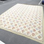 A large floral decorated cream ground wool carpet. 610 x 436cm.