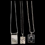 A group of 3 silver necklaces with abstract design pendants