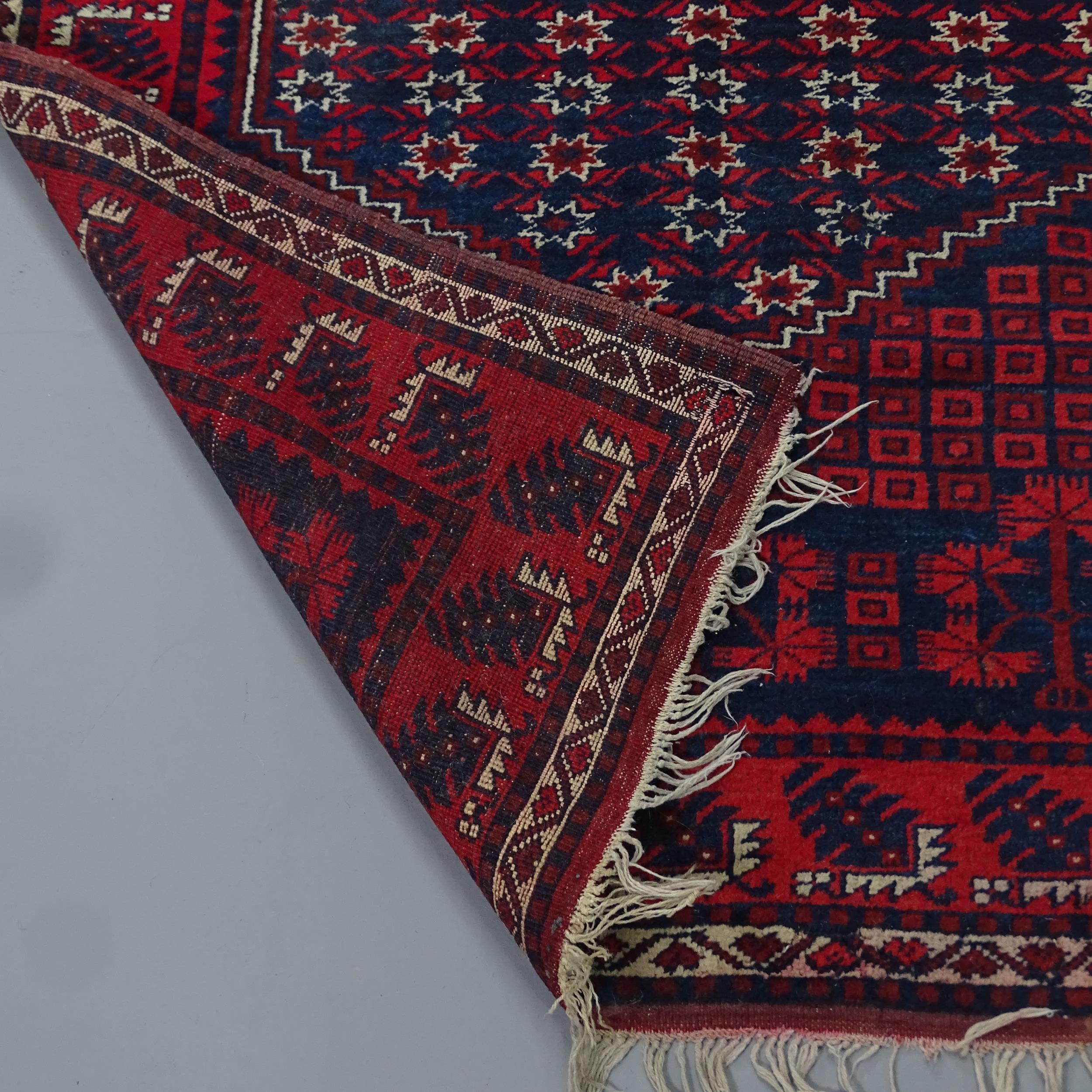 A red-ground Afghan rug. 183x115cm - Image 2 of 2