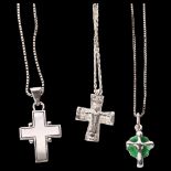 A group of 3 silver crucifixes and chains, 1 decorated with green enamel