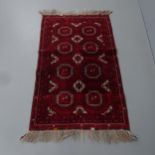A red-ground Buchara rug. 146x90cm. Fading to lower quarter. Some damage to fringe.