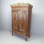 An Indonesian hardwood two door cupboard, with single drawer to base and chip-carved decoration.