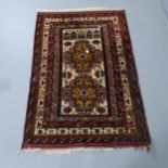 A red-ground Persian design rug. 133x92cm.